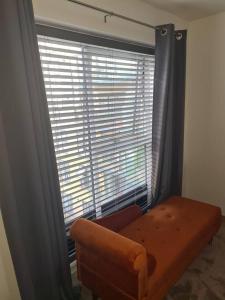 a room with a window with a couch and a chair at Remarkable 1-Bed Apartment in Dartford in Dartford