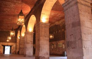 a large room with columns and lights in a building at Hacienda El Carmen Hotel & Spa in Portes Gil