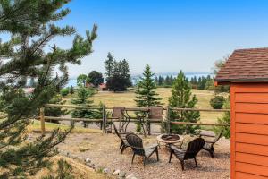 a patio with chairs and a table and a fence at The Lake House in Polson