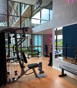 a gym with a treadmill and a bench in a room at Flat Sunny Hall Porto de Galinhas PE Piscina Privativa in Porto De Galinhas +28 photos