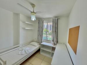 a white room with a bed and a window at Condomínio Vivence in Fortaleza +30 photos