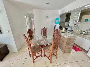 a dining room table and chairs in a kitchen at Condomínio Vivence in Fortaleza
