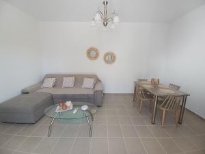 a living room with a couch and a table at Pension Annoula in Archangelos