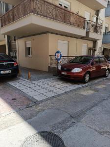 two cars parked in front of a building at 3 min from central station No2 private free parking in Thessaloniki
