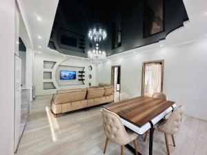 a dining room with a table and a couch at House in Tsikhisdziri in Kobuleti