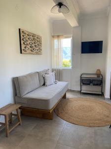 a living room with a couch and a table at Thassa Beach Apartment No1 (with mountain view) in Leonidion