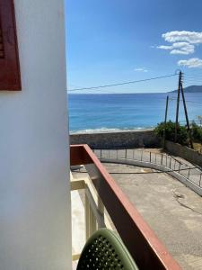 a balcony with a view of the ocean at Thassa Beach Apartment No1 (with mountain view) in Leonidio +12 photos