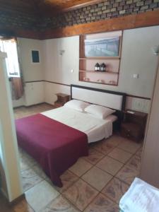 a bedroom with a large bed in a room at 56s.m comftorable studio,airport area in Anemómylos