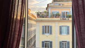 a view from a window of a building with blue shutters at NTB Roma in Rome