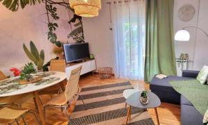 a living room with a blue couch and a table at Charming Vólos House 2 in Volos