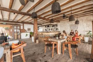 a group of people sitting at tables in a room at Niken Beachfront Tulum Hotel in Tulum