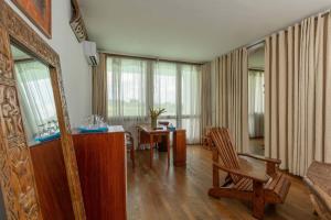 a living room with a couch and a table and chairs at Hostellerie de la Sanaga in Edéa