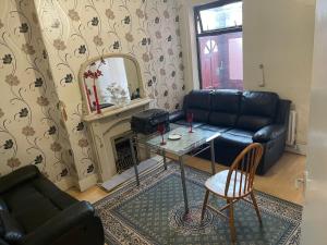 a living room with a couch and a table and a mirror at Quite Broad Rest 3 in Longford