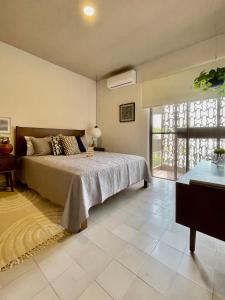 a bedroom with a bed and a large window at Casa San Fernando by Barrio México in Guadalajara
