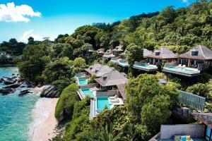 an aerial view of a resort on a hill next to the water at Hilton Seychelles Northolme Resort & Spa in Beau Vallon