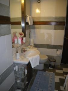 a bathroom with a sink and a toilet at Villa Georgie in Tsagarada