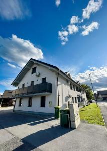 a white building with a balcony on the side of it at Perfect Place for two in Kranj