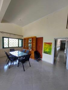 a dining room with a glass table and chairs at Lio's Villa in Xilokéra