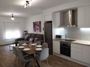 a kitchen and living room with a table and chairs at CAN’SELMA 2 in Chella