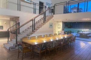 a large dining room with a long table and chairs at One Park Lane in Southwell