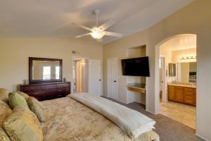 a bedroom with a large bed and a flat screen tv at Stunning Phoenix Oasis with Golf Course Views! in Phoenix