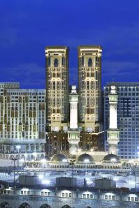 a group of tall buildings in a city at night at Conrad Makkah in Makkah