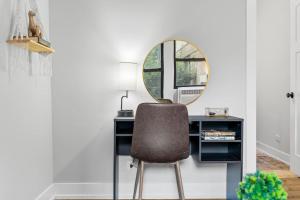 a desk with a chair and a mirror at 1-bedroom Chic Apartment with Laundry - Brompton 55-57 rep in Chicago