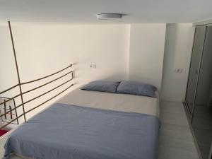 a small bedroom with a bed in a room at Sunny studio apartment Chiara in Tivat +9 photos