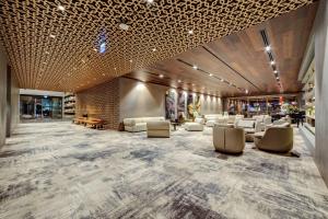 a large lobby with white chairs and tables at DoubleTree by Hilton Adana in Adana