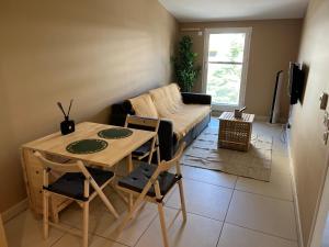 a living room with a table and a couch at T2 Prado Plage / Vélodrome in Marseille