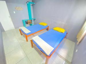 two beds in a room with a stove at STAY POUSADA in Recife