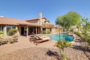 a backyard with a swimming pool and a house at Stunning Phoenix Oasis with Golf Course Views! in Phoenix