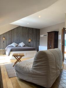 a bedroom with a bed and a table in it at La Ferme Des Eglantines in Nivelles