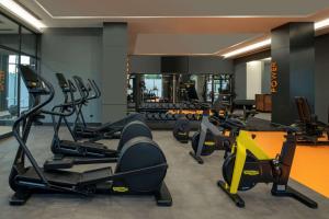 a gym with several treadmills and cardio machines at DoubleTree by Hilton Manisa in Manisa