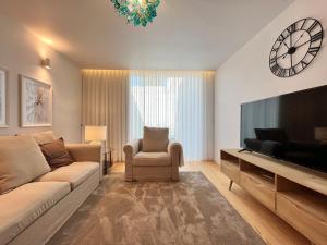 a living room with a couch and a flat screen tv at Nomads Lux - 2BDR Almada Private Porto in Porto