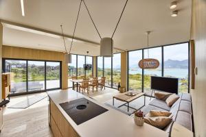 a living room with a couch and a table at NEW! Lofoten Luxury Home near Henningsvaer in Lyngværet