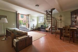 a living room with a staircase and a couch and a table at Casa Orsolini in Lucca