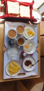 a table with plates of breakfast food and bread at Oasis Resort in Skardu
