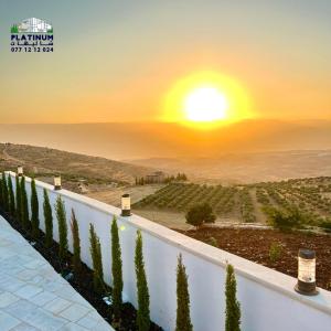 a view of the sunset from the terrace of a winery at Platinum 1 Villa in Al Salt
