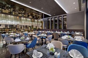 un comedor con mesas y sillas y un restaurante en DoubleTree by Hilton Istanbul - Piyalepasa, en Estambul