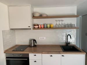 a kitchen with a sink and a counter top at Sunny studio apartment Chiara in Tivat