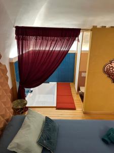 a bedroom with a bed and a red curtain at Sea Riad in Molfetta