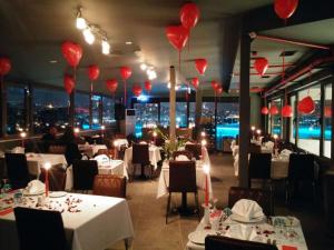 a restaurant with white tables and red lanterns at DoubleTree by Hilton Istanbul - Sirkeci in Istanbul