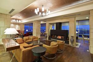 a living room with a couch and a fireplace at DoubleTree By Hilton Avanos Cappadocia in Avanos