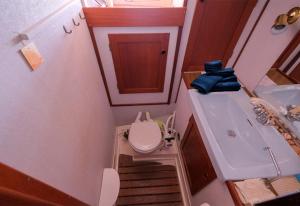 a small bathroom with a toilet and a sink at Your Sailing House Sardinia in San Teodoro