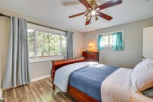 a bedroom with a bed and a ceiling fan at Eureka Springs Apartment Blue Moon Ridge in Eureka Springs