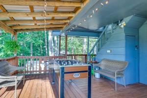 a deck with a table and chairs on a deck at Eureka Springs Apartment Blue Moon Ridge in Eureka Springs