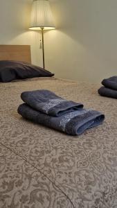 two blue towels are laying on a bed at Apartement GT in Nice