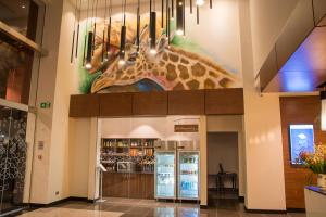 a giraffe painting on the wall of a building at Hilton Garden Inn Nairobi Airport in Nairobi