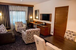 a hotel room with a desk and a room at Hilton Garden Inn Nairobi Airport in Nairobi